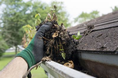 Cleaning Gutter with a Scoop